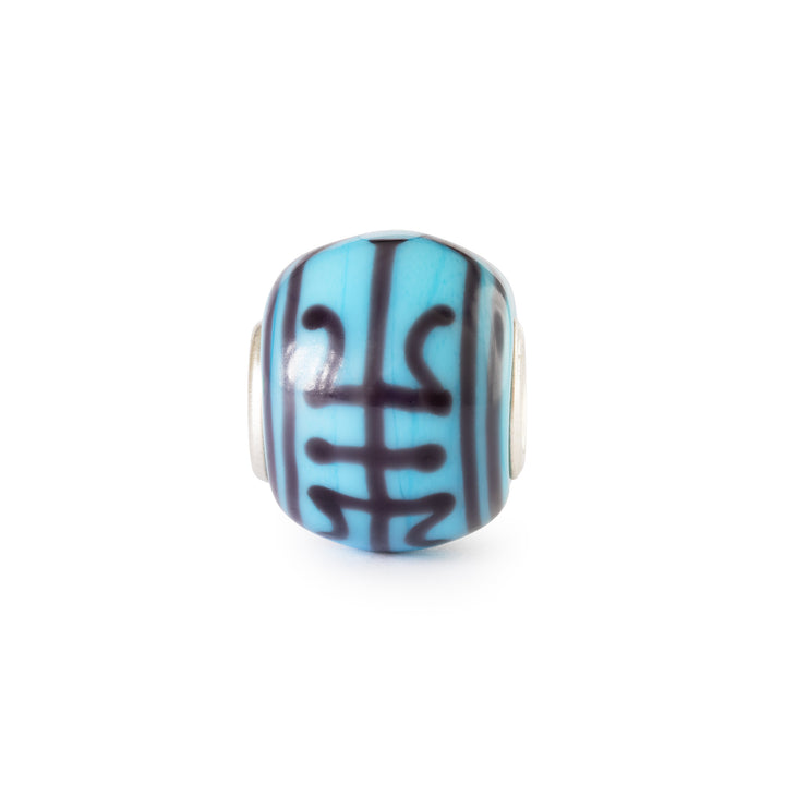 Blue and black striped bead on a white background