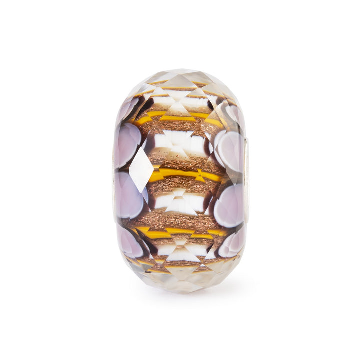 Decorative glass bead with geometric pattern on a white background