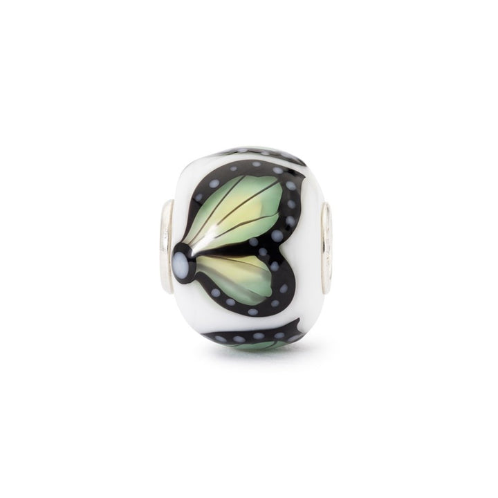 Glass charm with butterfly design on a white background