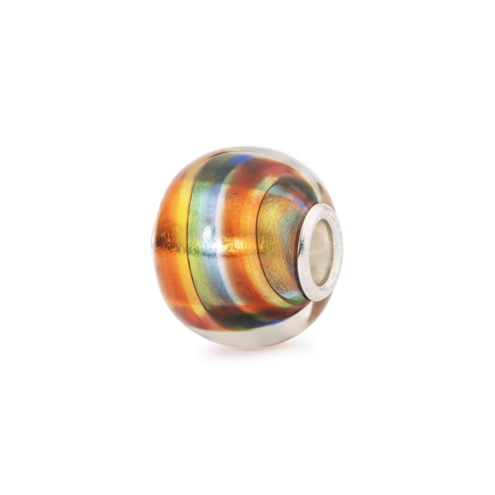 Multicolored glass bead with silver core on a white background