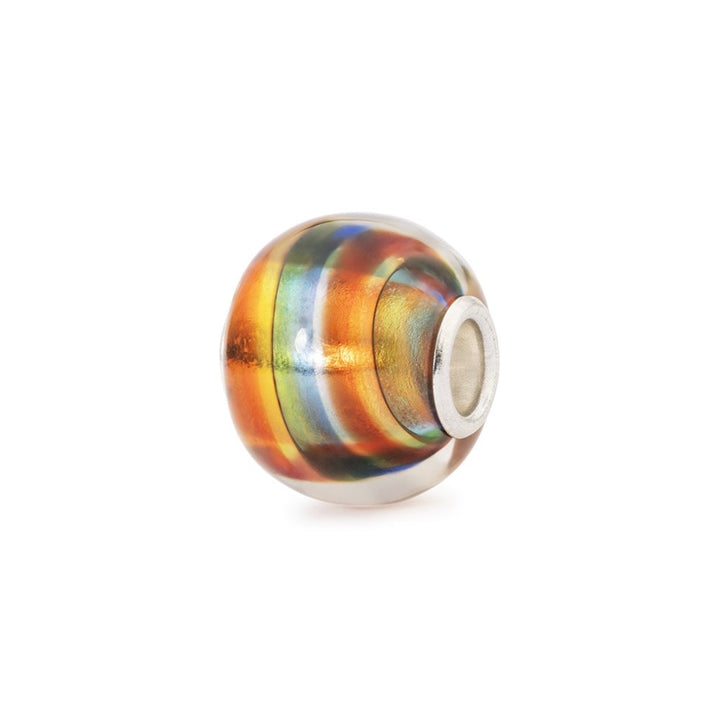 Multicolored glass bead with silver core on a white background