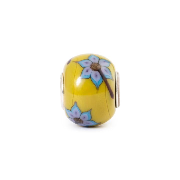 Yellow bead with floral design on a white background