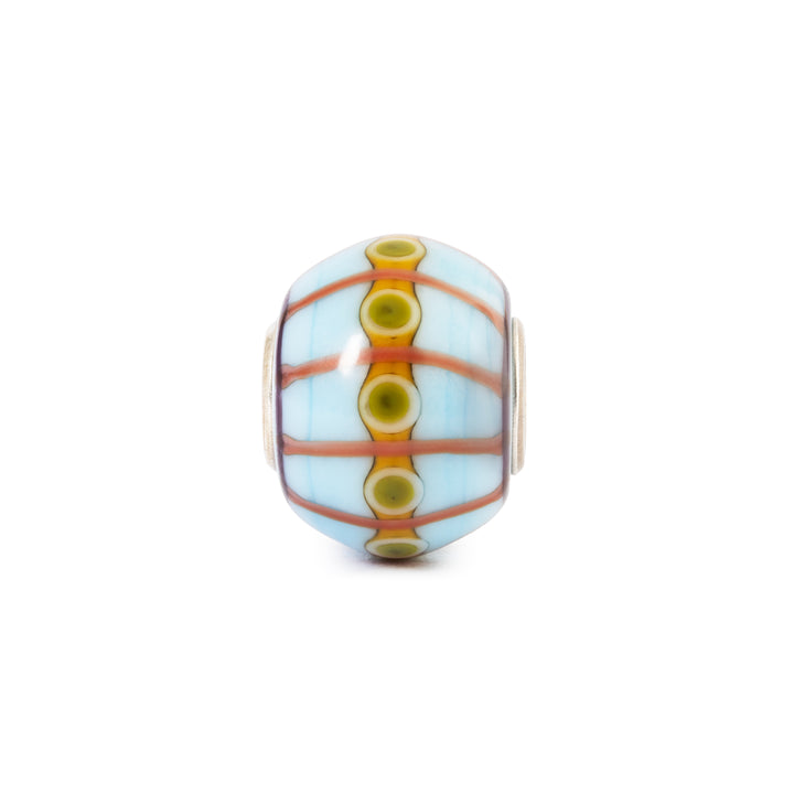 Decorative glass bead with colorful pattern on a white background