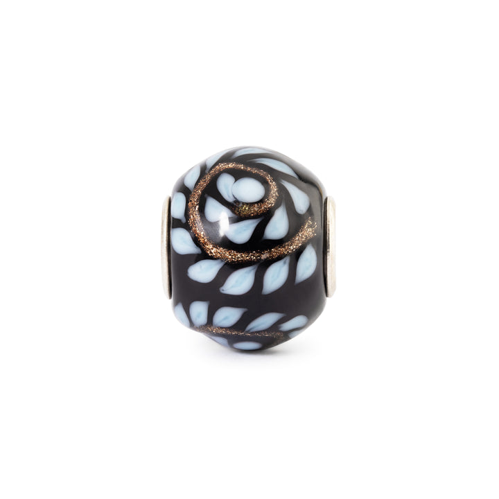 Decorative bead with black and white pattern on a white background