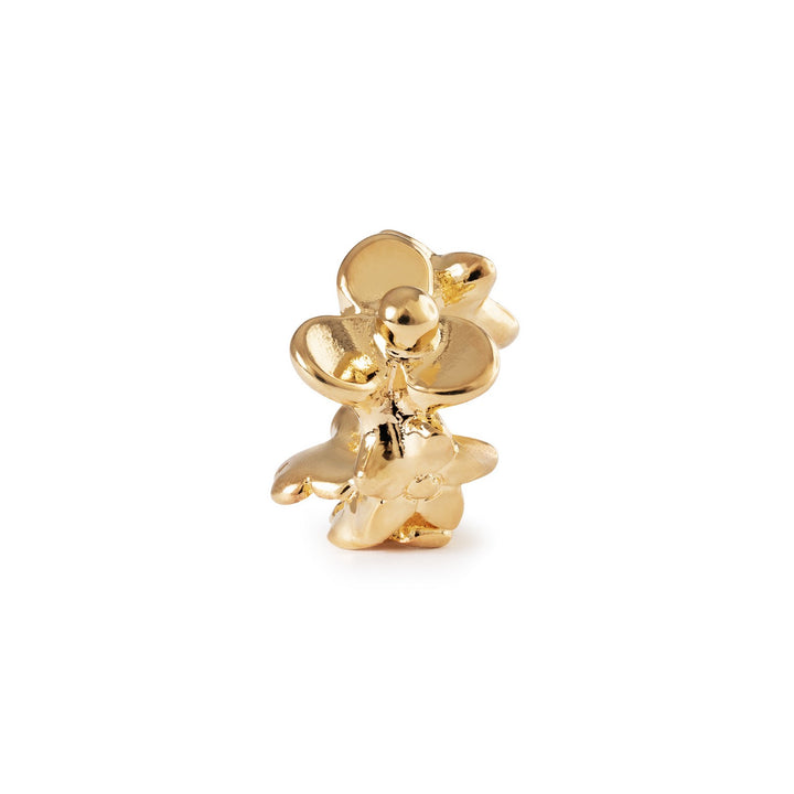 Gold flower-shaped earring on a white background