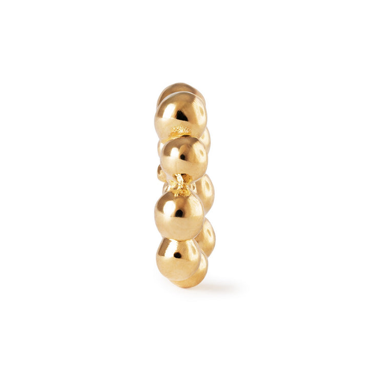 Gold ring with stacked circular beads on a white background