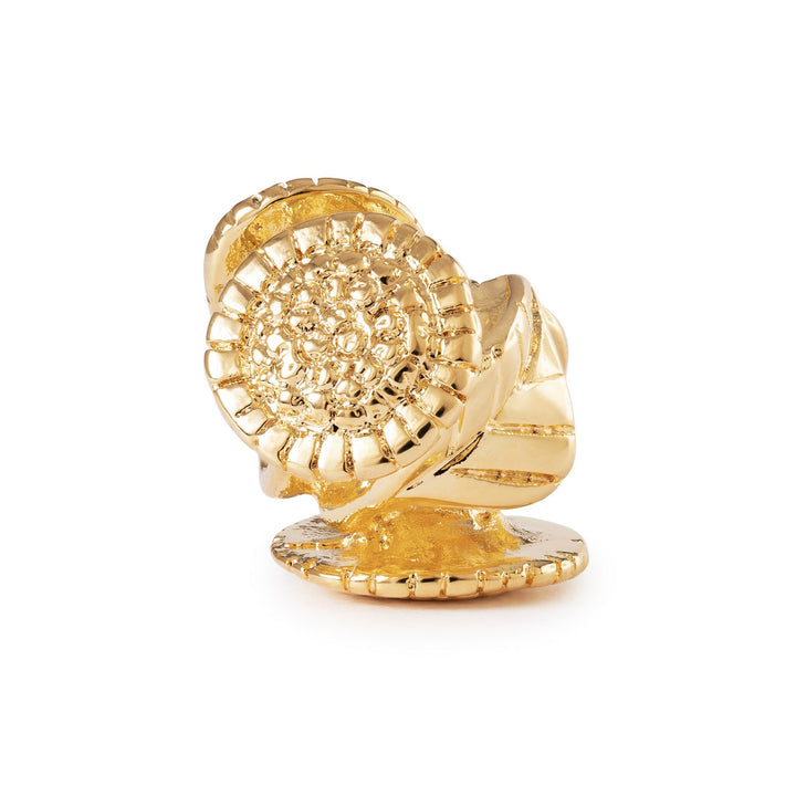 Gold ring with intricate design on a white background