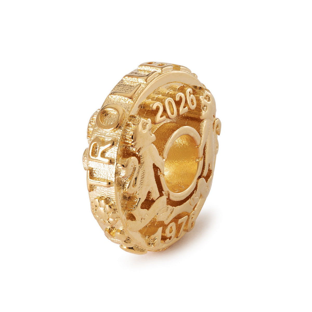 Gold charm with '2026' and '1974' inscriptions on a white background
