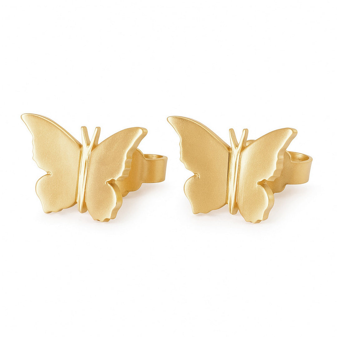 Gold butterfly earrings on a white background