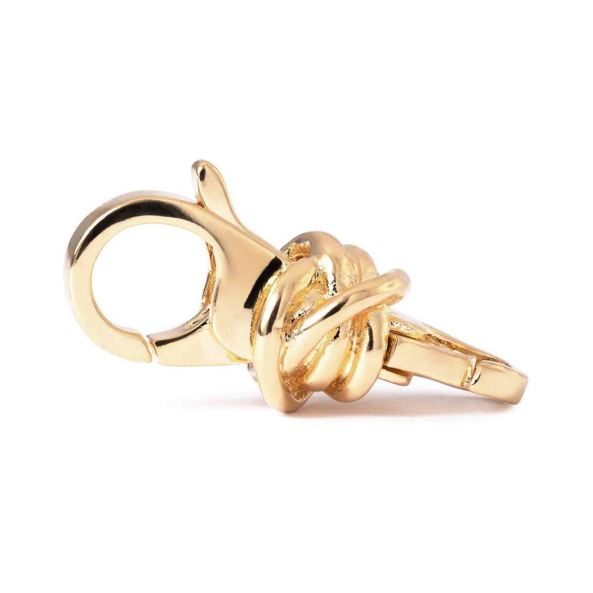 Gold knot-shaped ring on a white background