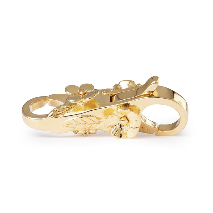Gold ring with floral design on a white background