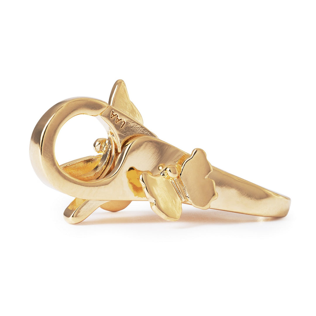 Gold shark-shaped ring on a white background