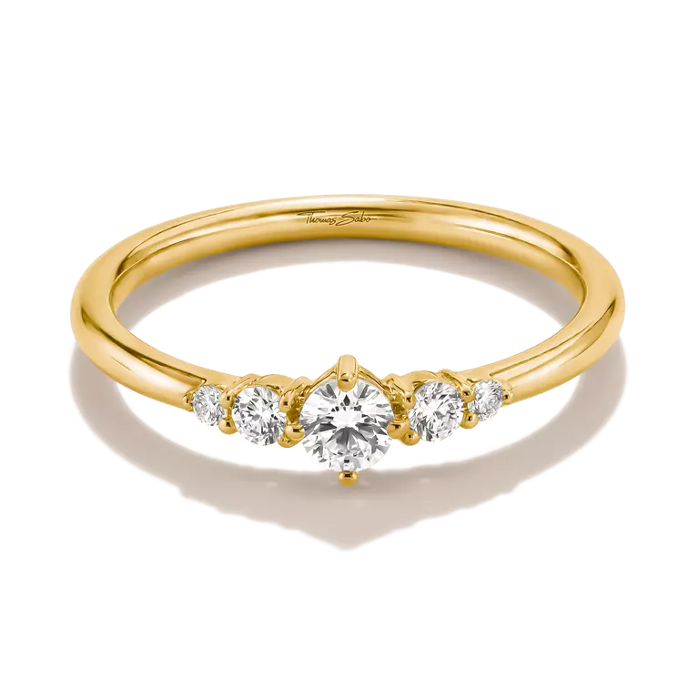 A yellow gold five-stone diamond ring with a round center stone and three smaller diamonds on each side, set against a clean white background.