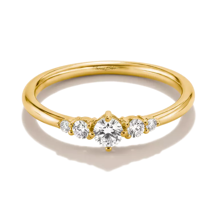 A yellow gold five-stone diamond ring with a round center stone and three smaller diamonds on each side, set against a clean white background.