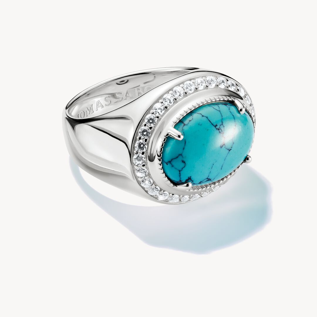 Silver ring with a turquoise stone on a white background