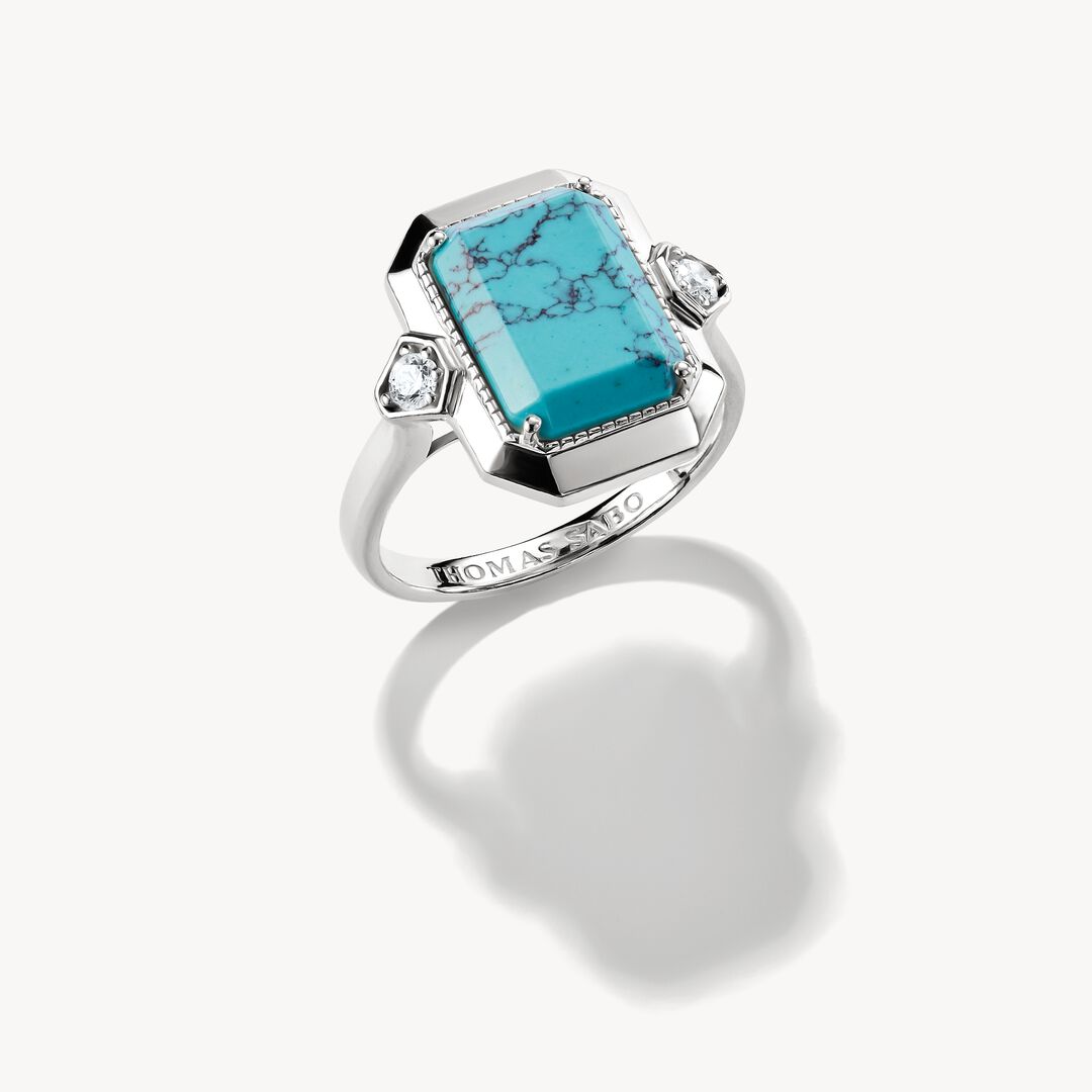 Silver ring with a turquoise stone on a white background