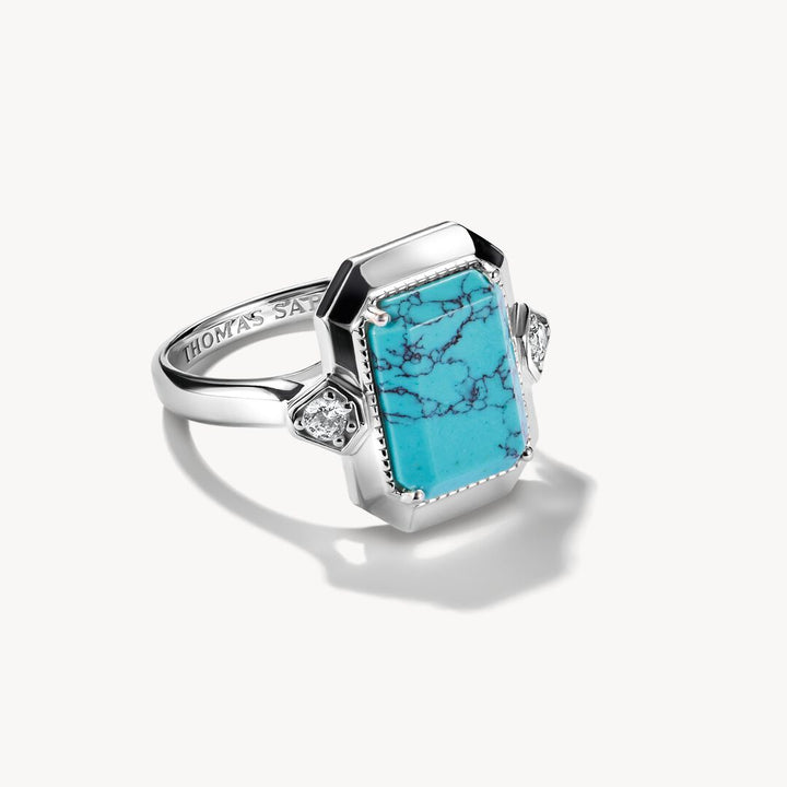 Silver ring with a turquoise stone on a white background