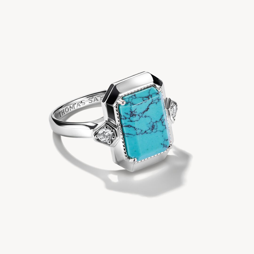 Silver ring with a turquoise stone on a white background
