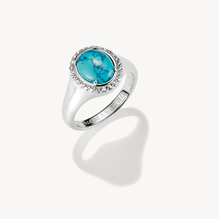 Silver ring with a turquoise stone on a white background