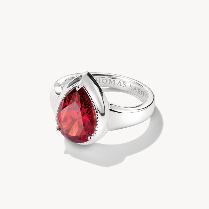 Silver ring with a red gemstone on a white background, featuring the brand 'Thomas Sabo'.