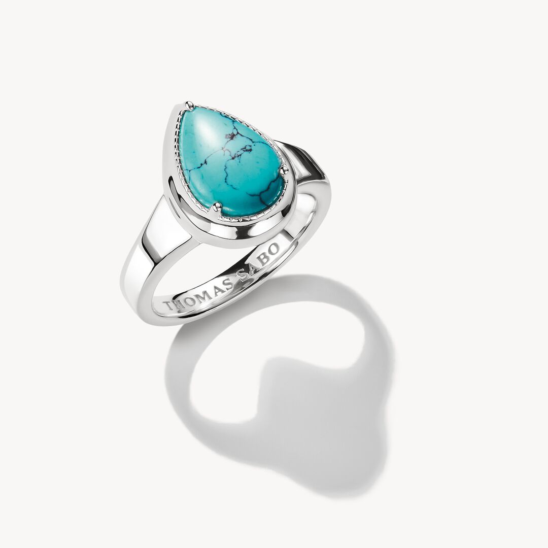 Silver ring with a turquoise stone on a white background