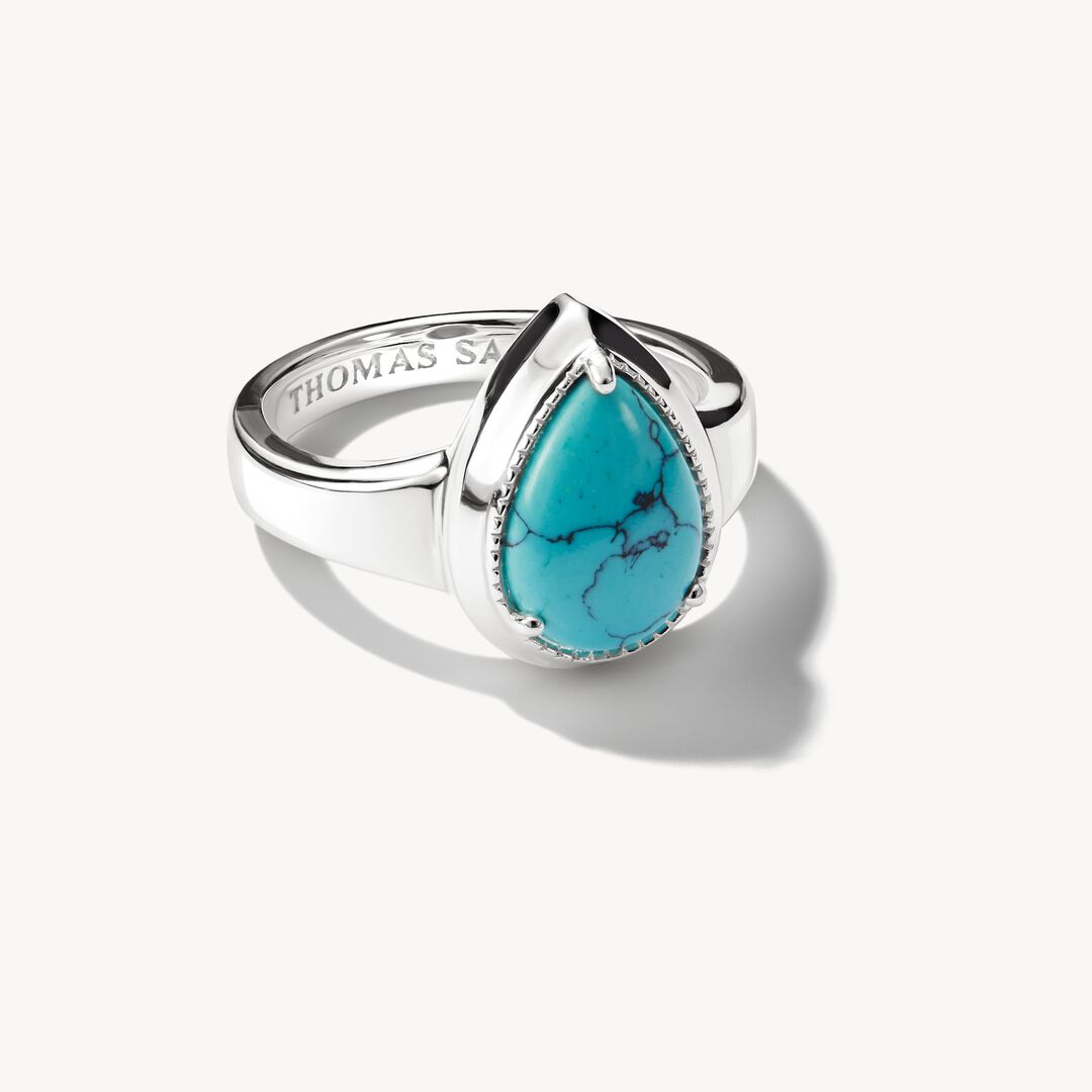 Silver ring with a turquoise stone on a white background
