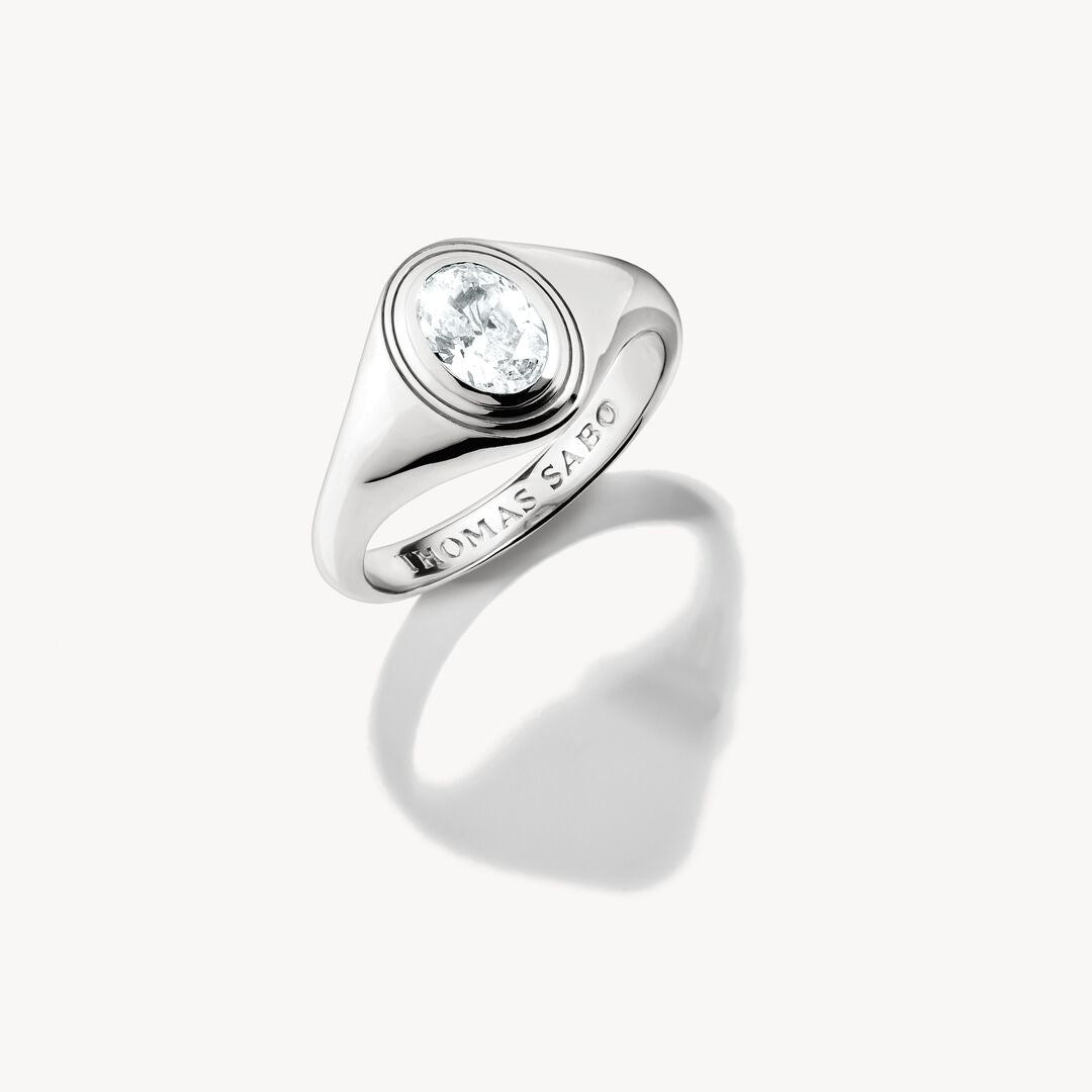 Silver ring with a clear gemstone on a white background