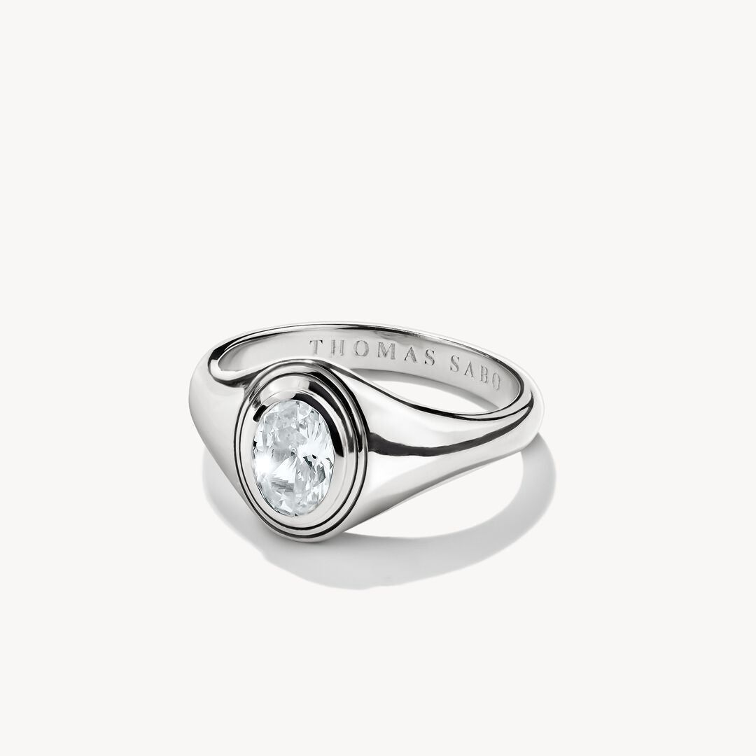 Silver ring with a clear gemstone on a white background