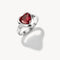 Silver ring with a red gemstone on a white background
