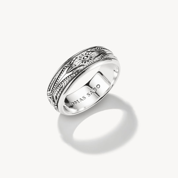 Silver ring with intricate design on a white background