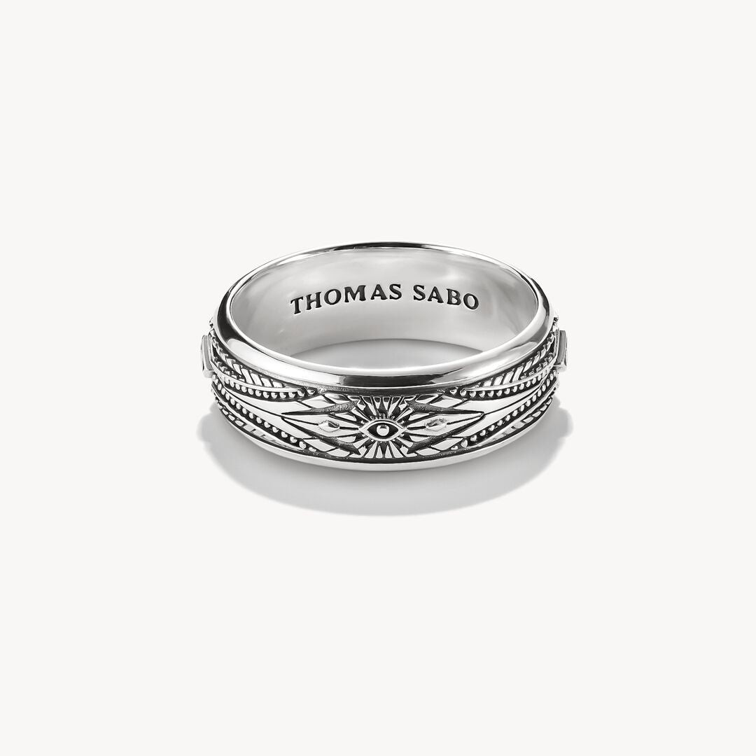 Silver ring with intricate design on a white background