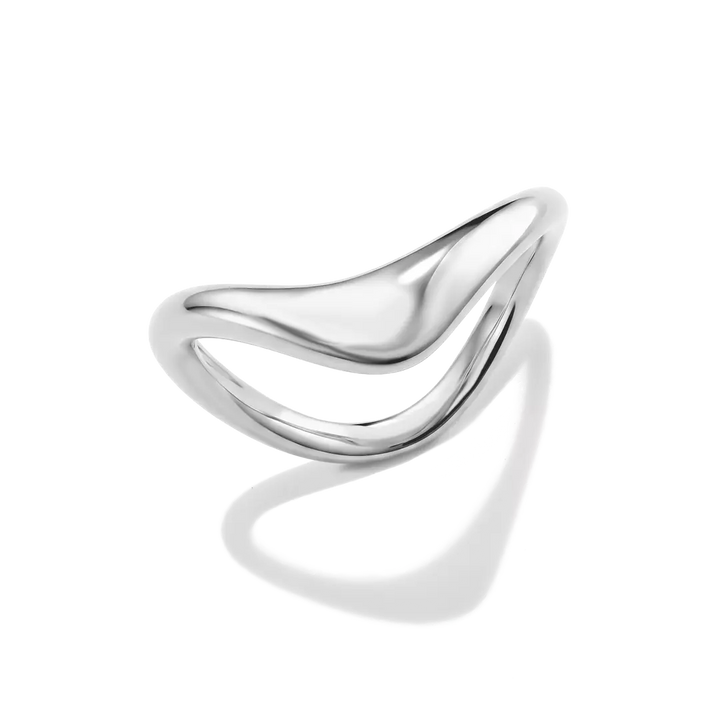 A polished silver ring with a fluid, wavy, open design, photographed on a clean white background with a soft shadow underneath.