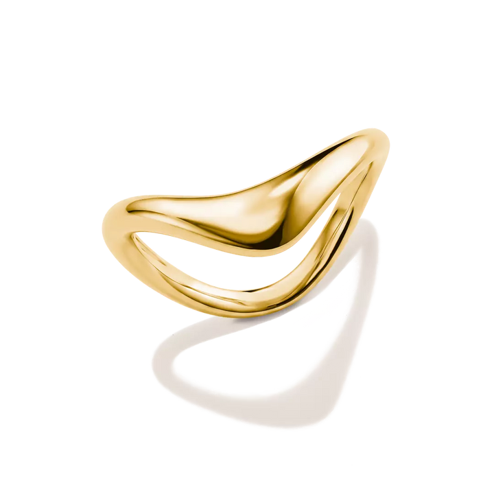 A polished gold abstract ring with a flowing, wavy open design, photographed on a clean white background with a soft shadow.