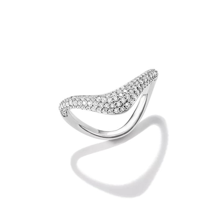 A silver-toned curved ring featuring a pavé-set row of clear stones across the top, photographed on a clean white background with a soft shadow beneath.