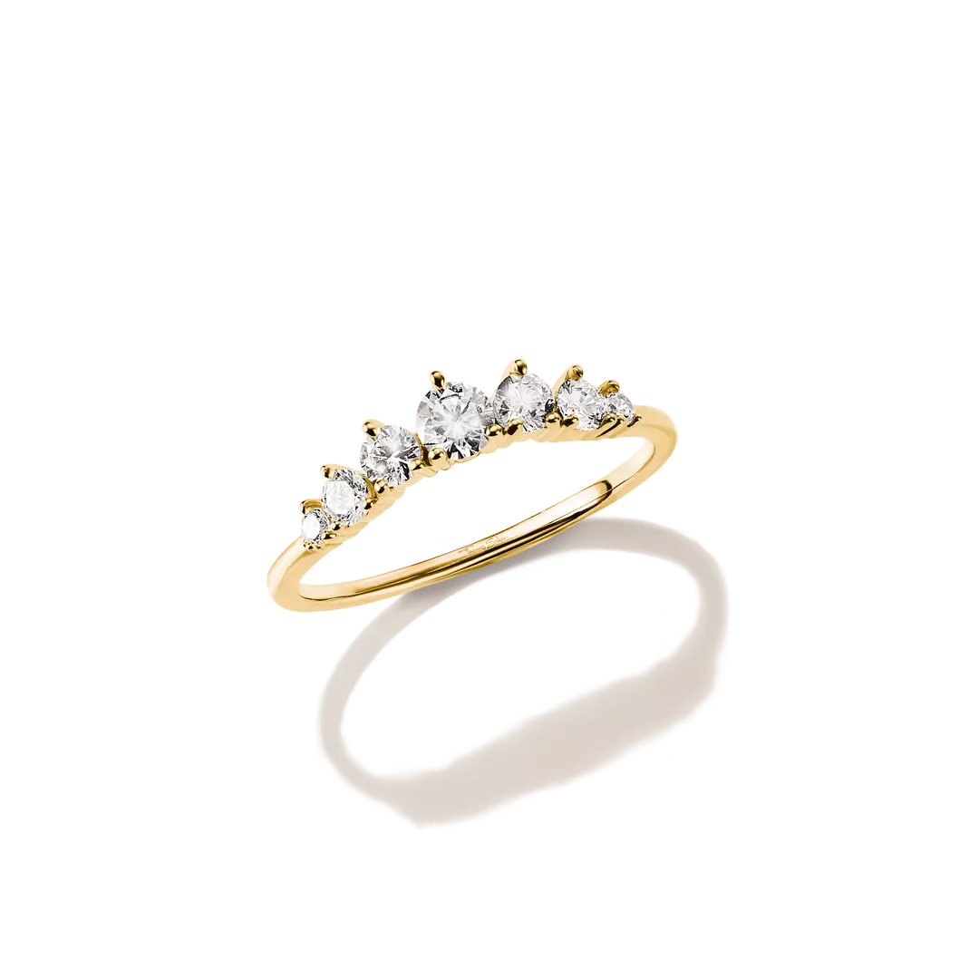 A yellow gold ring featuring five marquise-cut clear gemstones set in a row, shown on a clean white background with a soft shadow.
