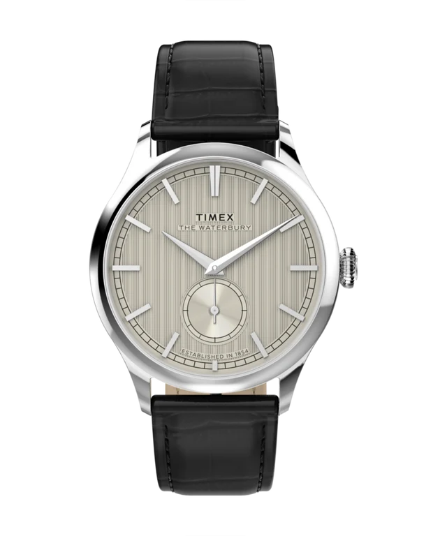 A Timex The Century watch with a silver stainless steel case, a cream-colored dial with vertical stripes, and a black leather strap, shown against a plain white background.