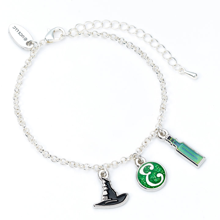 Silver bracelet with witch hat, green circle, and rectangular charm on a white background
