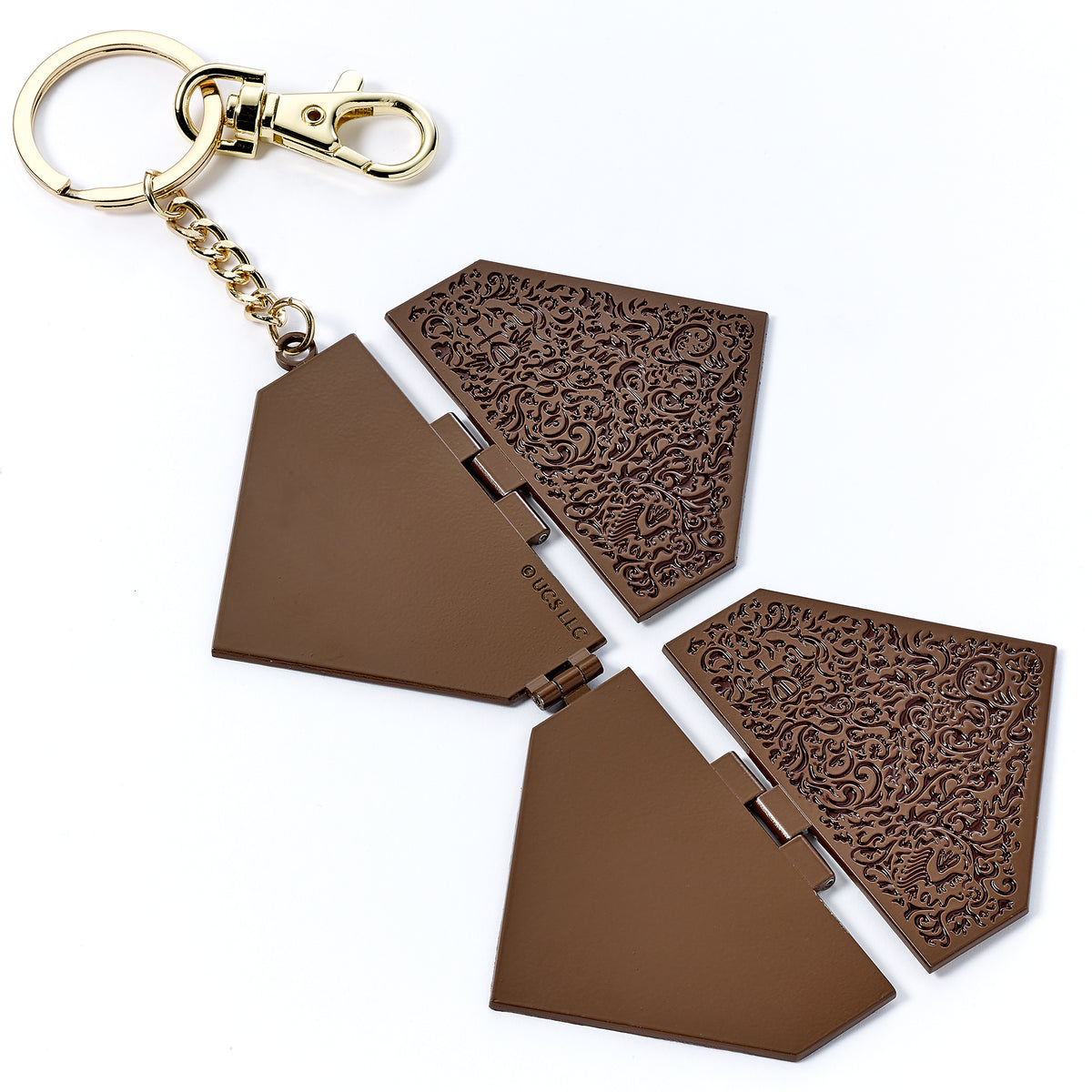 Brown decorative keychain with intricate patterns on a white background