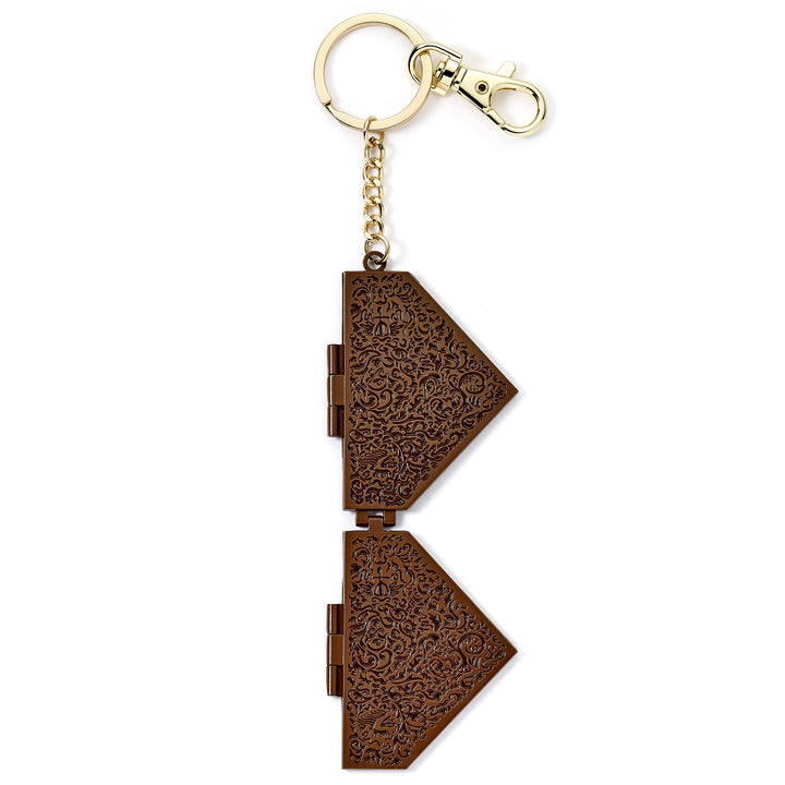 Decorative keychain with intricate patterns on a white background