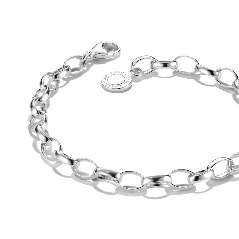 A polished silver chain bracelet with oval links and a lobster clasp, featuring a small round tag engraved with 'CRAFTED BY ST. HANSEN'.