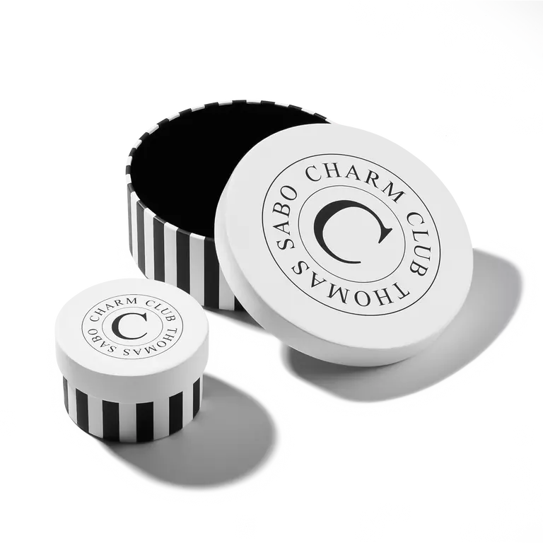 Sabo Charm Club product packaging with black and white design on a white background