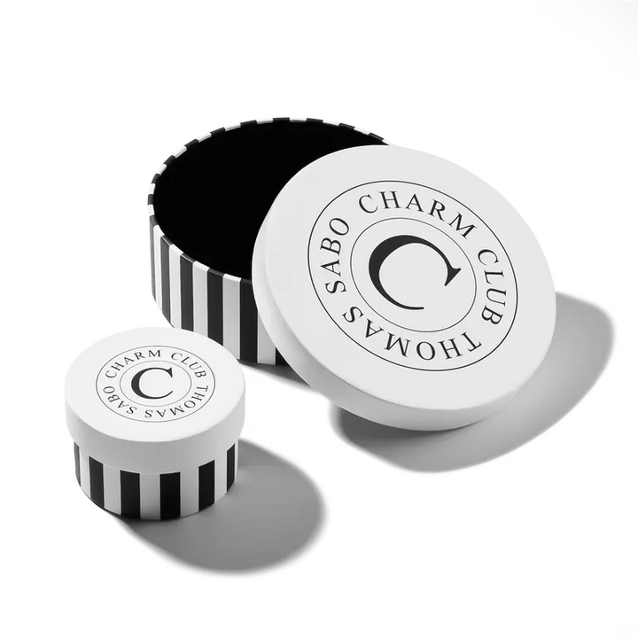 Sabo Charm Club product packaging with black and white design on a white background