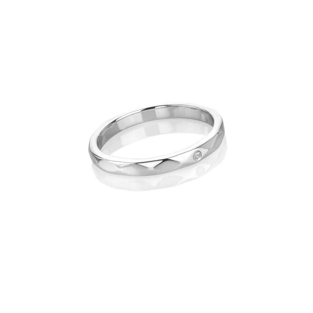 Silver ring with a small diamond on a white background