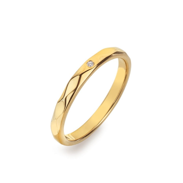 Gold ring with a diamond on a white background