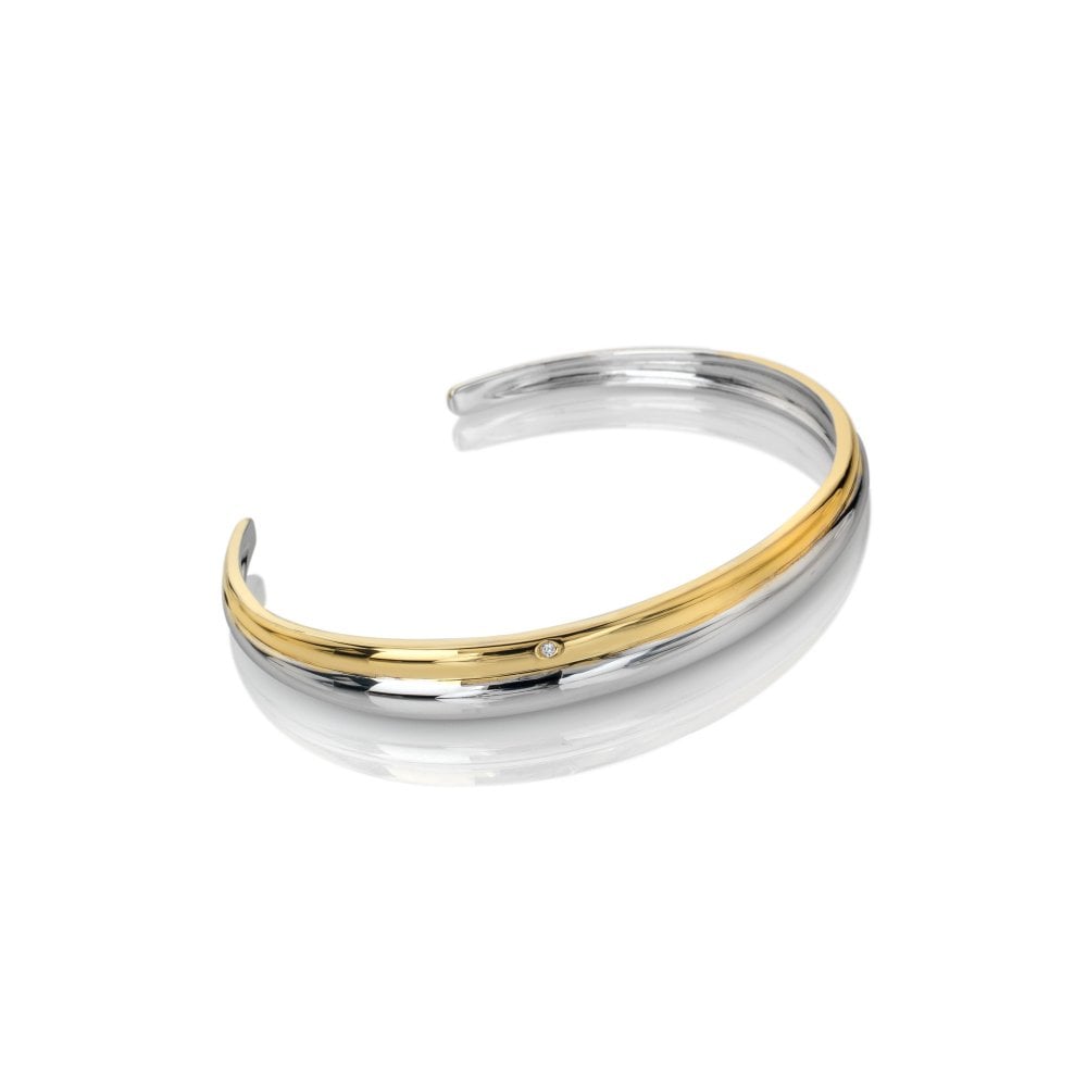 Two-tone gold and silver bangle on a white background