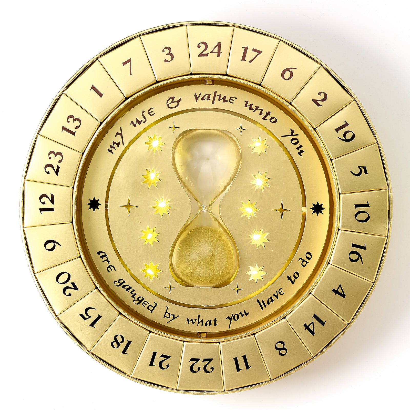 Gold circular decorative item with hourglass design and text on a white background