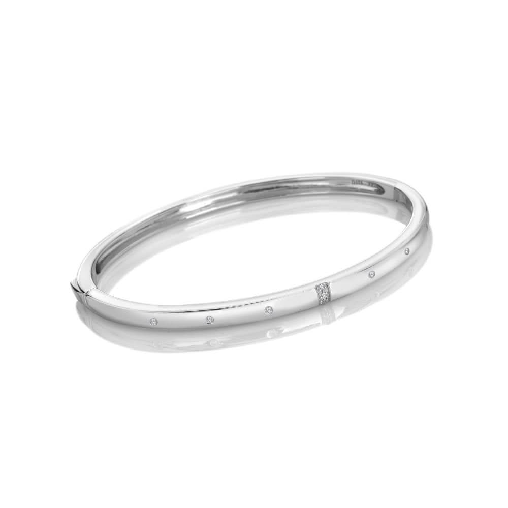 Elegant Sterling Silver Much Loved Slim Bangle DC217 featuring delicate design and adorned with six sparkling White Topaz stones and a single hand-set diamond, reflecting luxury.