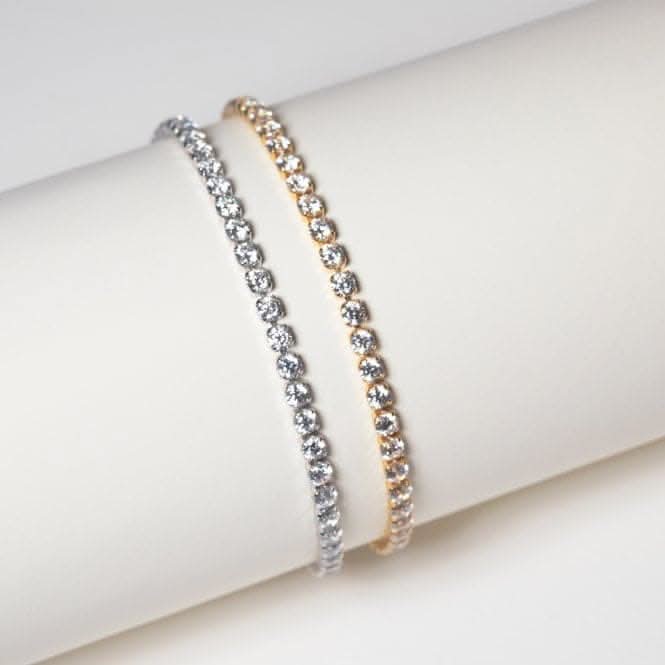 Elegant display of two stylish bracelets made with sparkling white zirconia, one in polished 925 sterling silver and the other in warm gold tones, artistically arranged on a soft, neutral background.